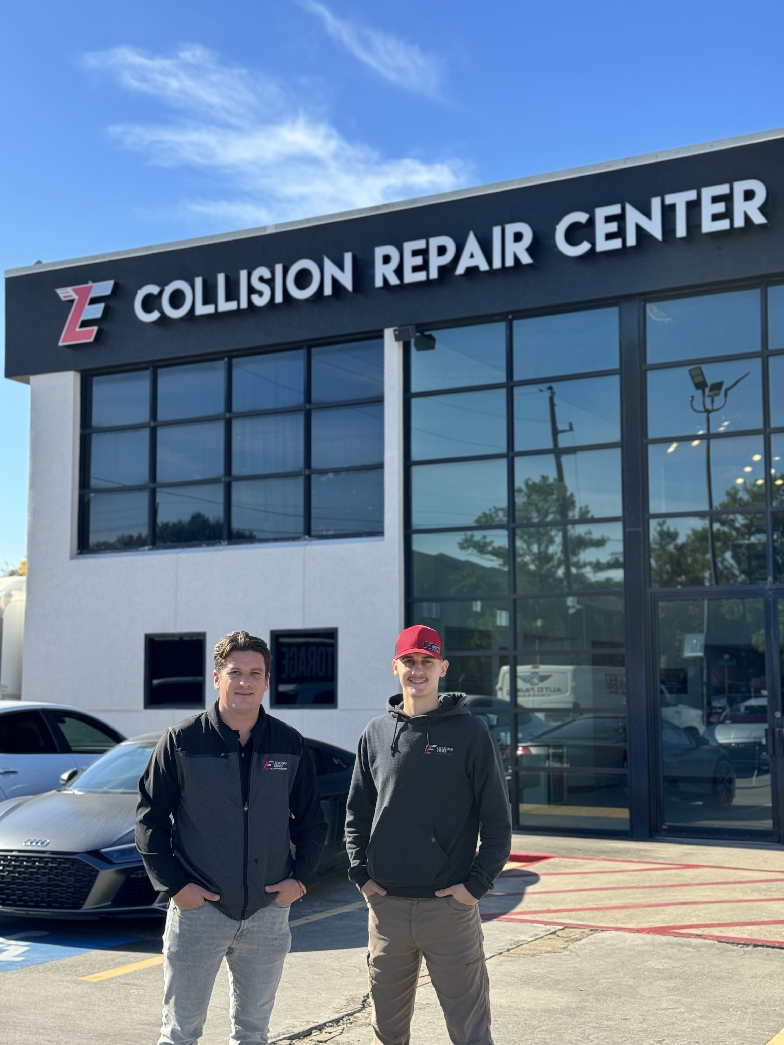 Kaleb and Adan outside a collision repair center